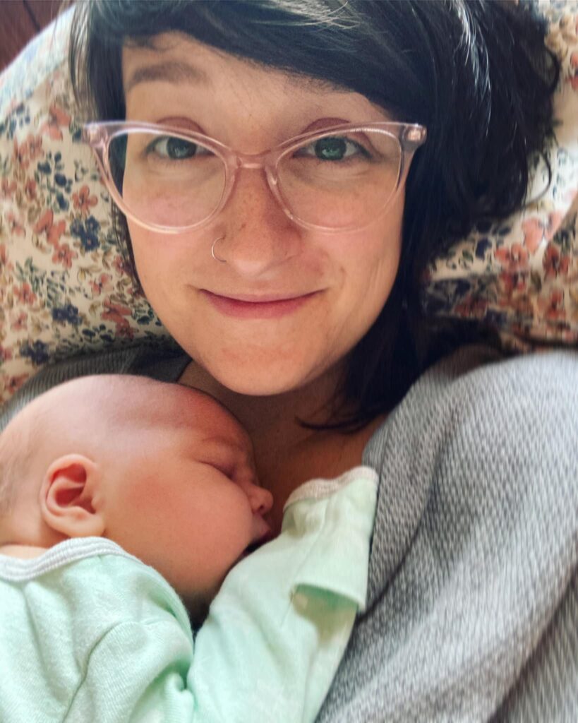 New parent cuddling with newborn baby