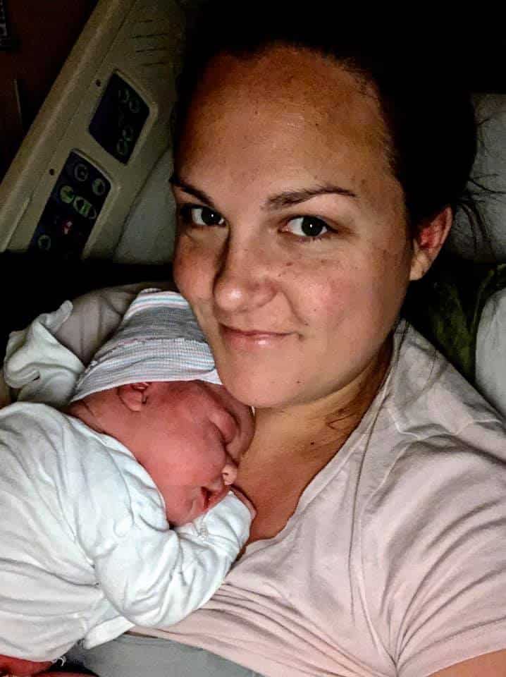 Hypno-mom Audrey holding newborn on her chest and smiling.