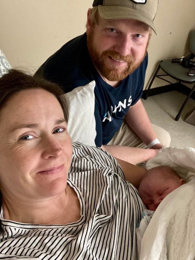 New parents holding newborn