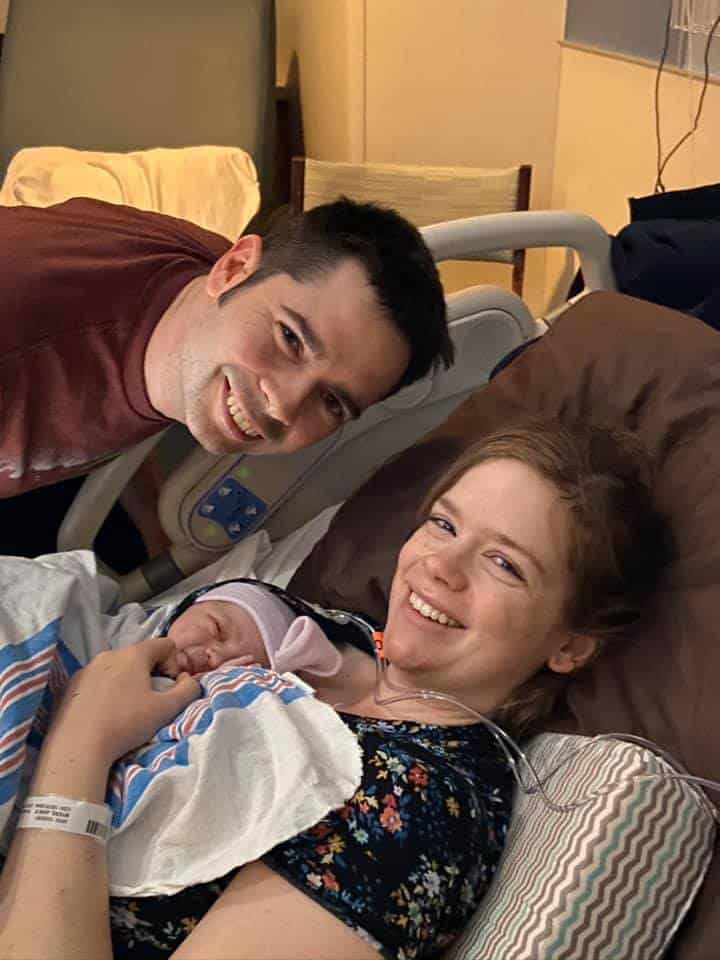 Hypno-mom and partner smiling with newborn in hospital
