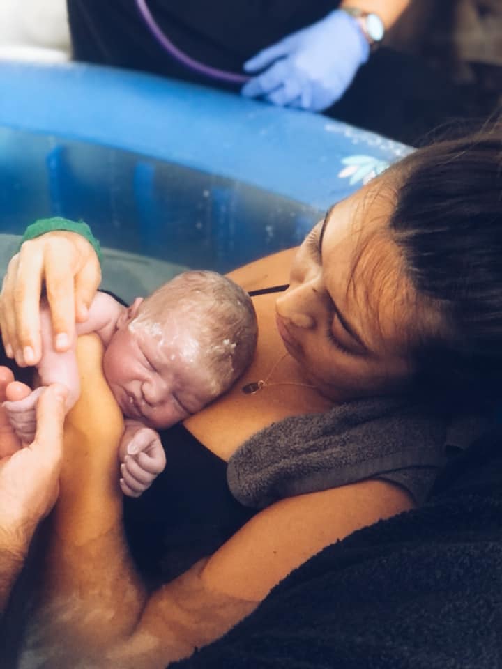 Birthing person and new baby just after waterbirth