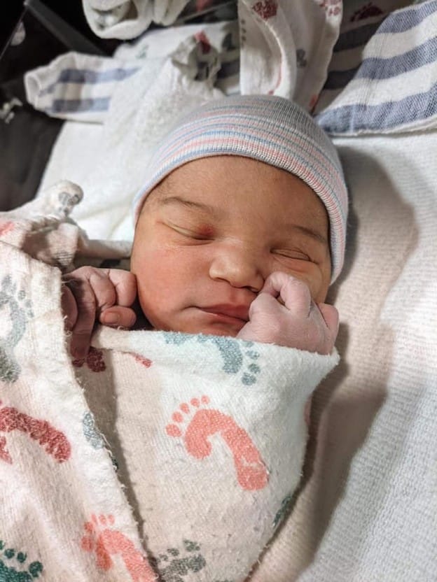 Newborn baby in a swaddle blanket