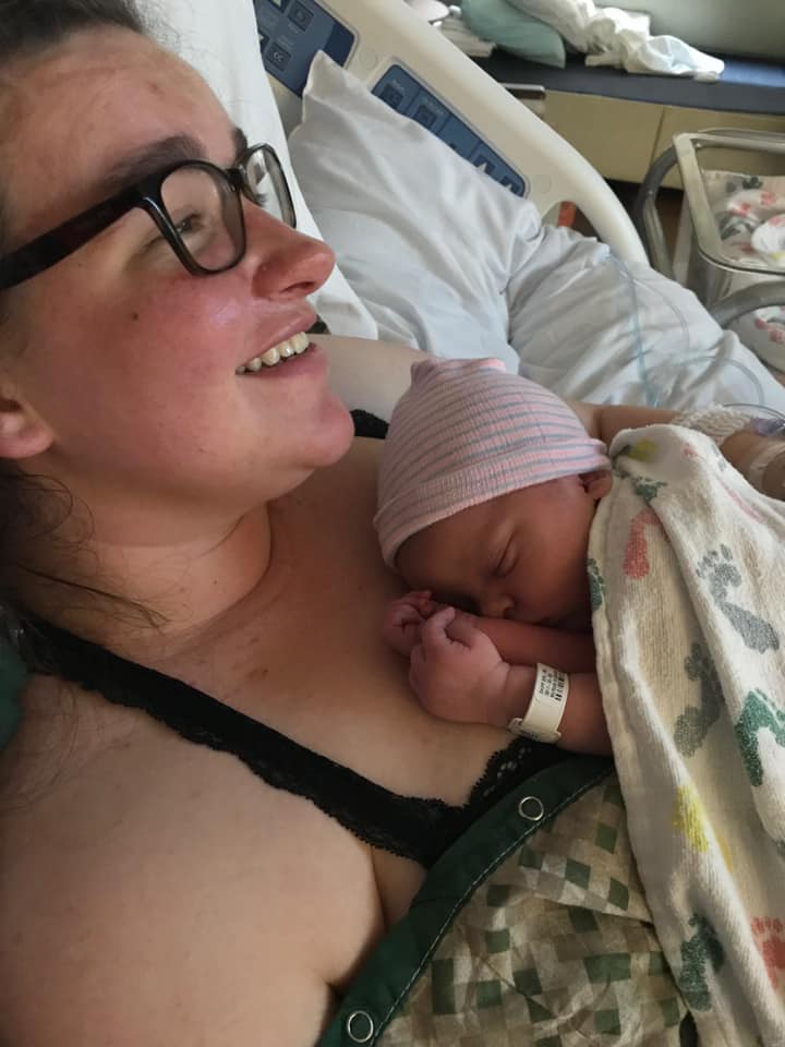 Hypno-mom smiling skin to skin with newborn