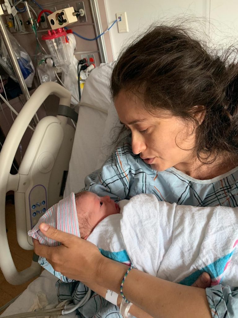 Hypno-mom Natalie in hospital bed holding newborn baby