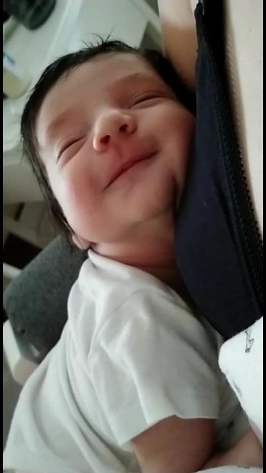 Hypno-mom Regina's baby smiling with his eyes closed.