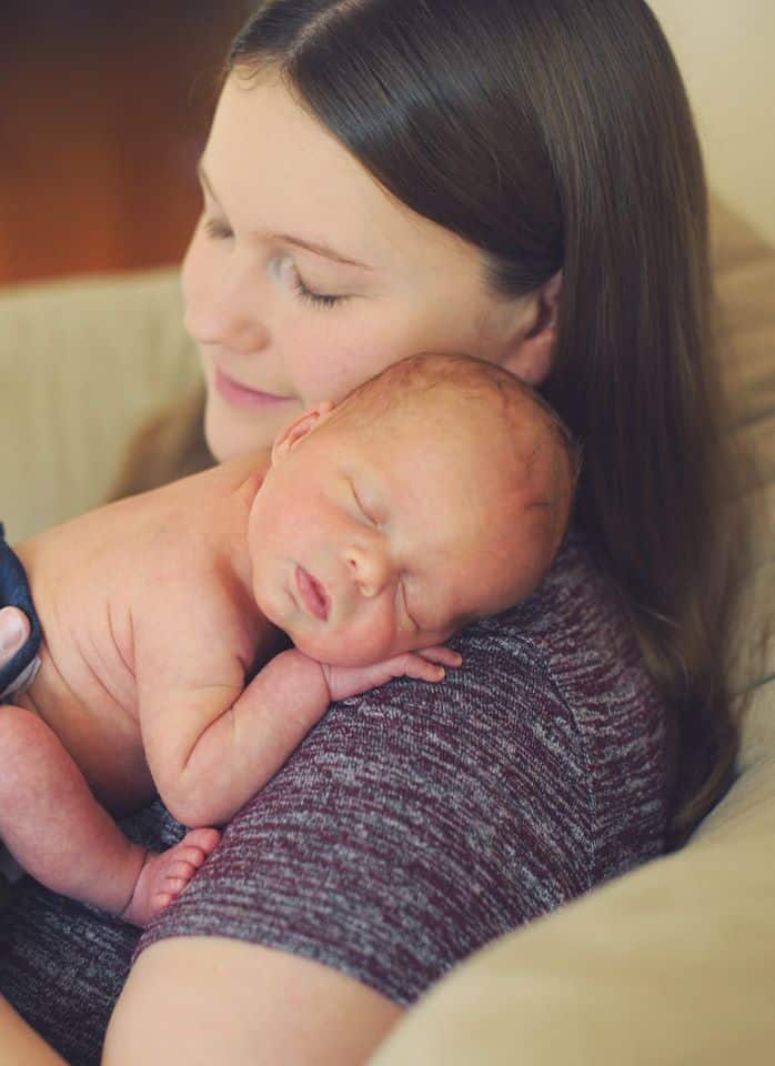 Hypno-mom cuddling newborn on her shoulder