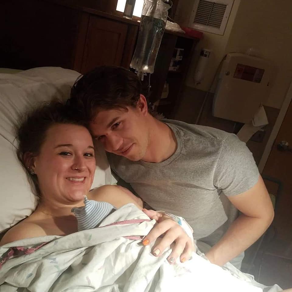 Hypno-mom Victoria and partner smiling and holding newborn